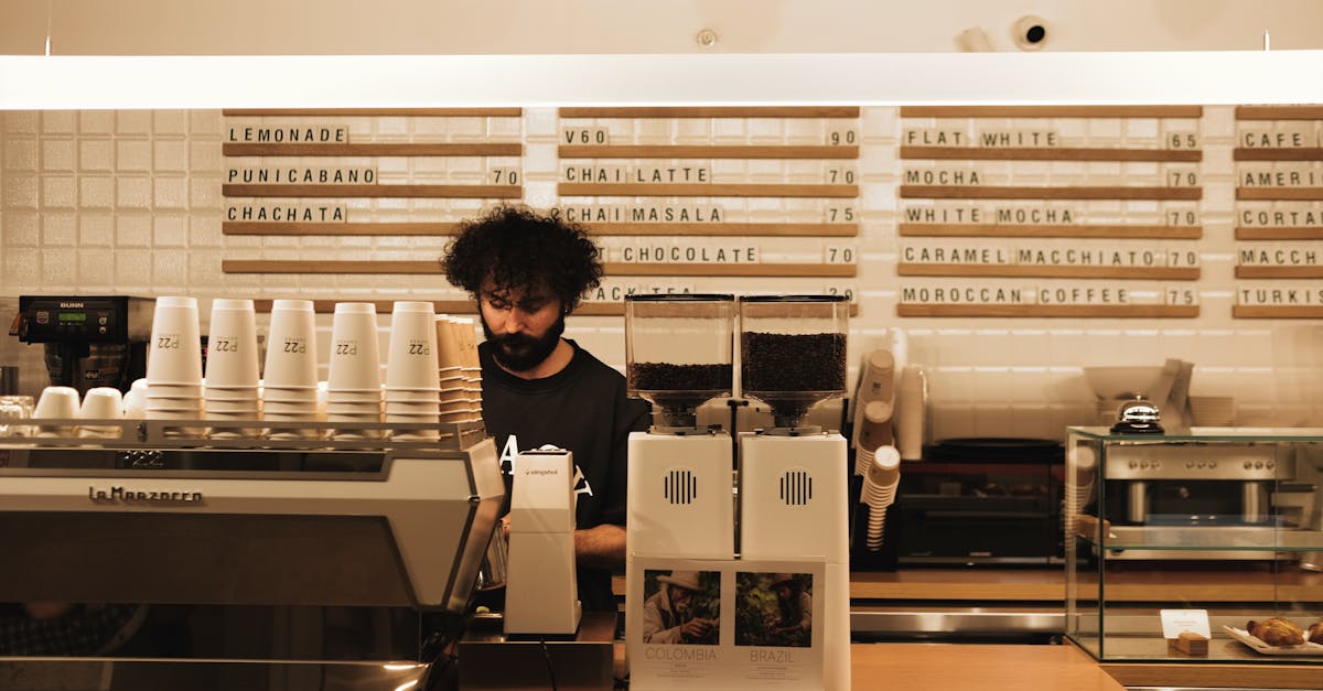 A barista making coffee using a professional espresso machine in a modern café.