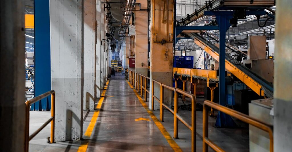 Бизнес-план в ФРП Казахстана для промышленного проекта 1 Wide view of a modern factory interior showcasing industrial machinery and conveyor systems.
