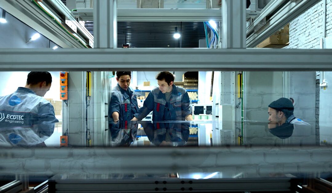 Engineers collaborate over advanced machinery in a high-tech indoor workspace.