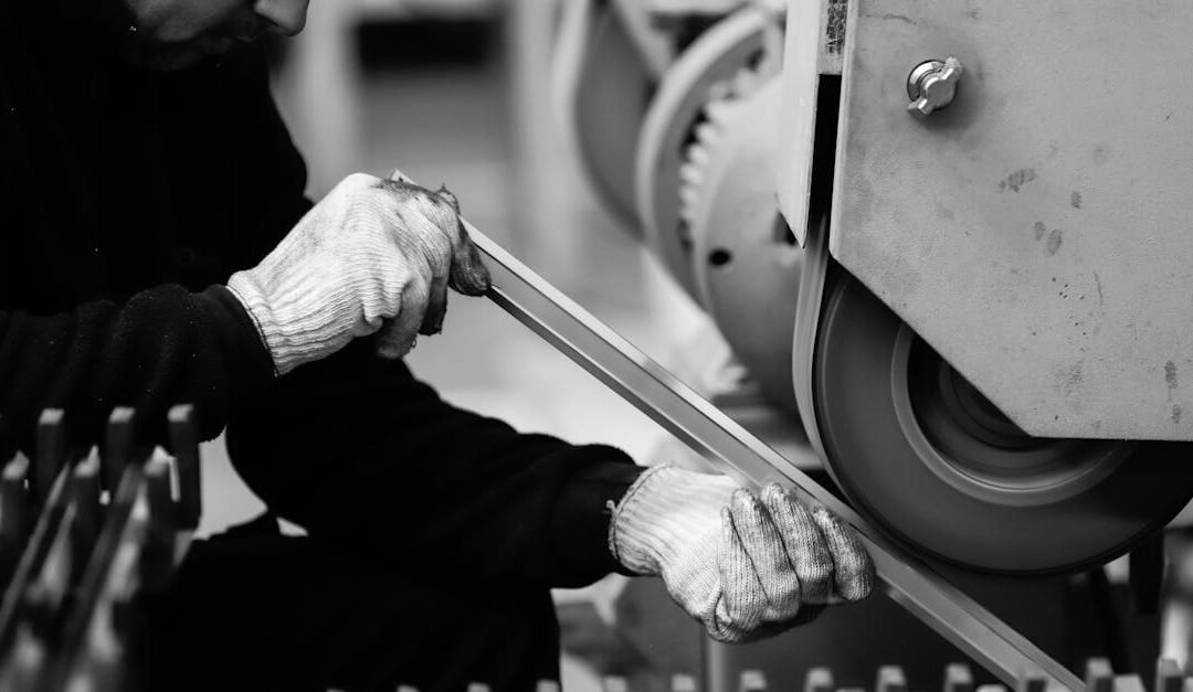 Man working with machinery in a factory setting, showcasing industrial production.