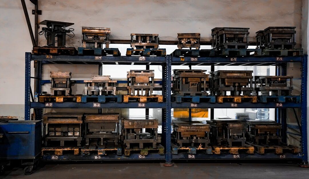 Metal molds neatly arranged on industrial shelving in a warehouse setting, showcasing order and efficiency.