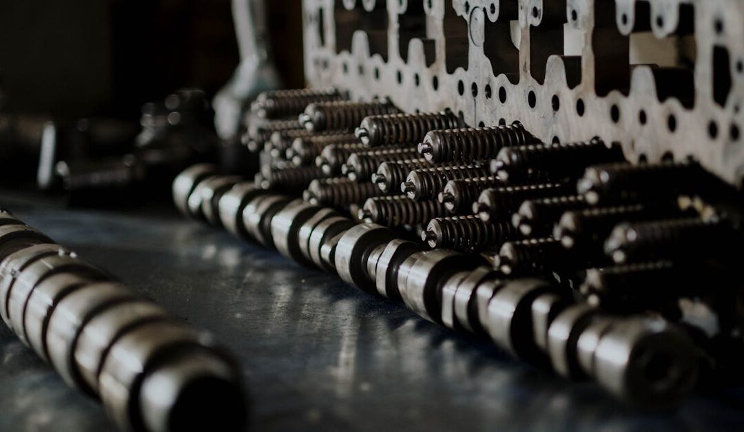 Detailed close-up of engine components including camshafts and springs on a workbench.