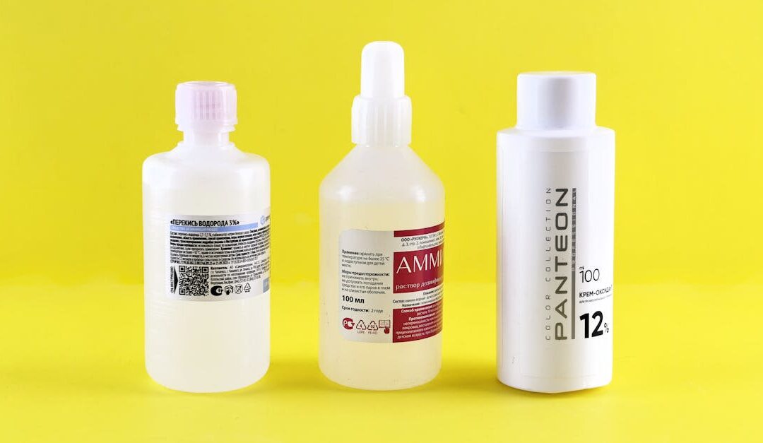 Three bottles with labels on a vibrant yellow surface emphasizing chemical substances.