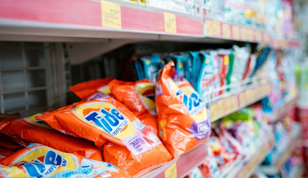 Vibrant selection of laundry detergents on a supermarket shelf, showcasing brands and variety.