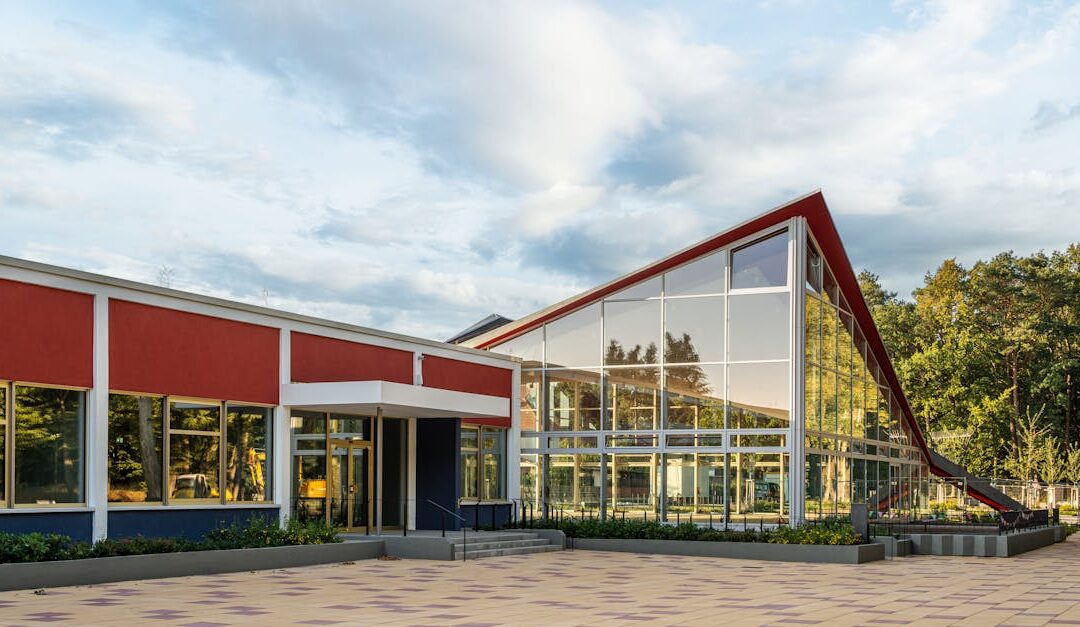 Striking geometric architecture with glass facade reflecting the surrounding nature.