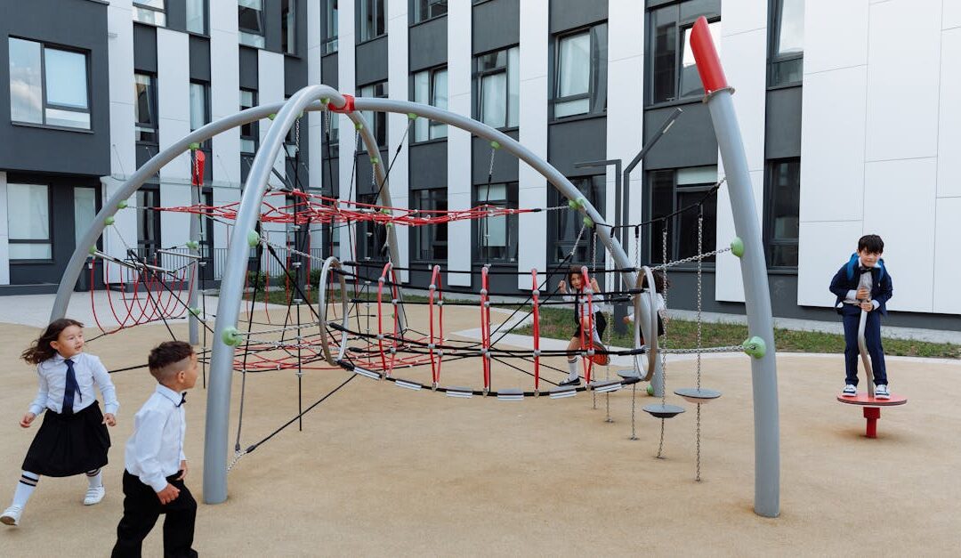 Children enjoy playtime in a modern school playground with climbing equipment.