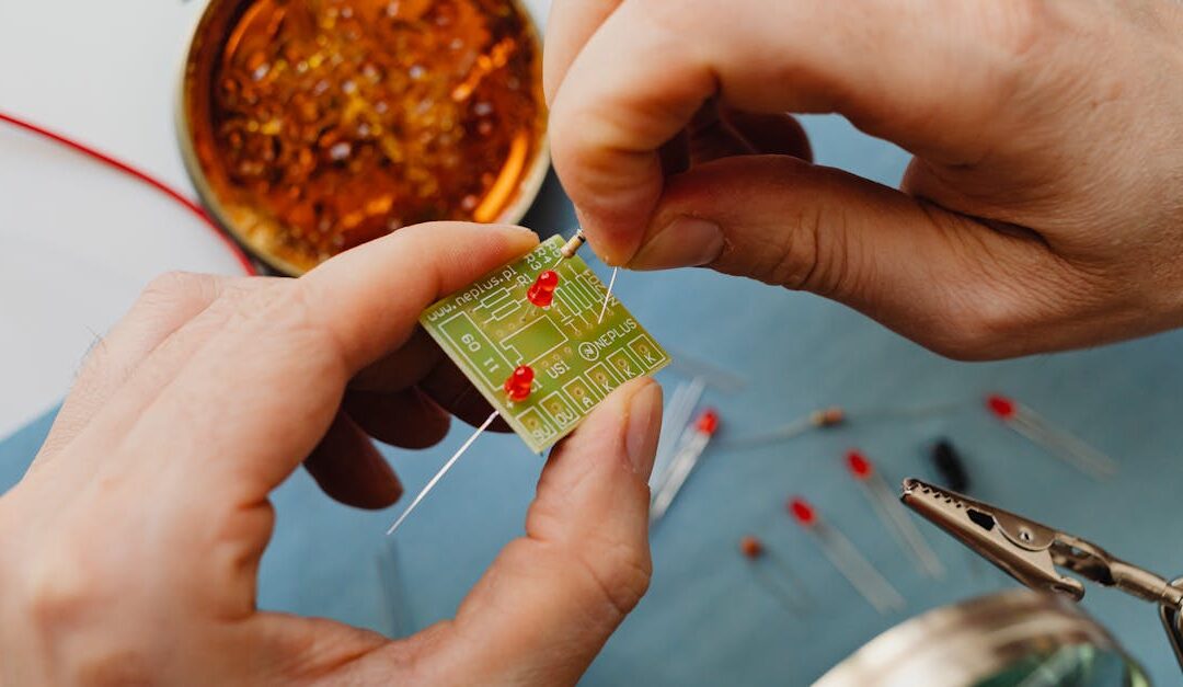Detailed shot of hand soldering components on a circuit board.