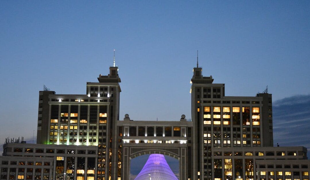 Majestic view of Astana's iconic architecture glowing against evening sky.