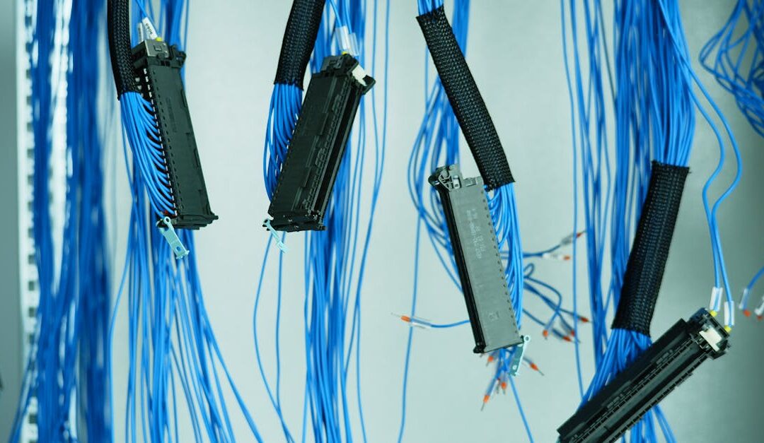 Close-up of blue ethernet cables hanging in a data center, highlighting technology connections.