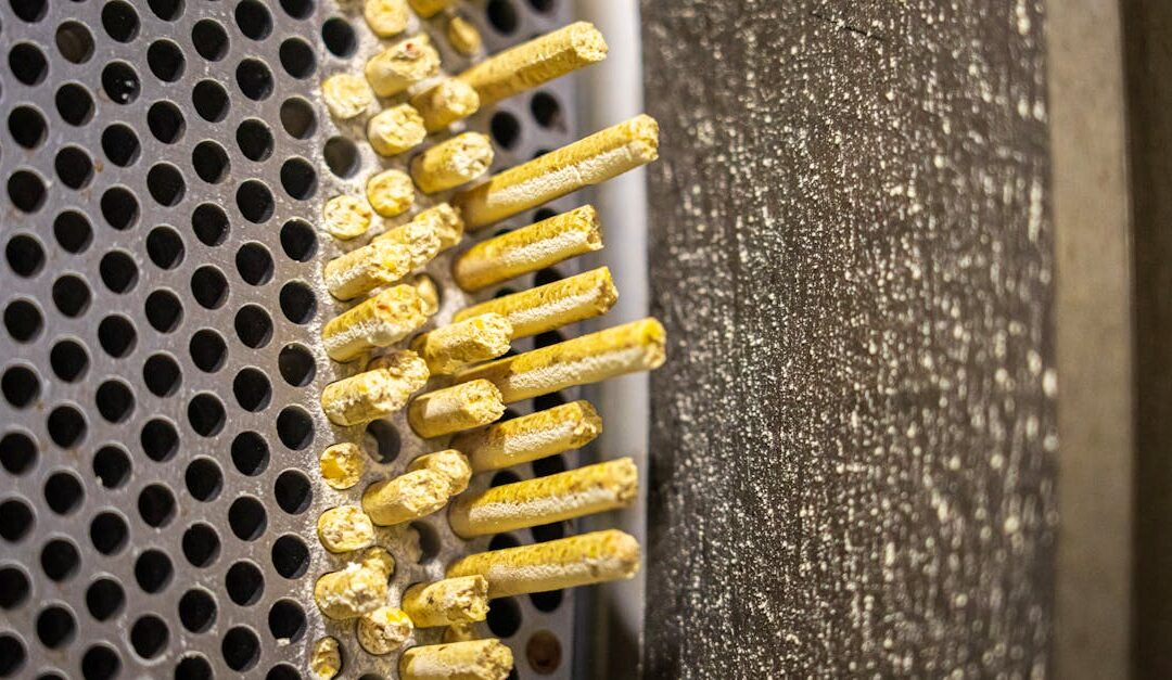 Detailed view of an industrial grinder's metal surface and grating.