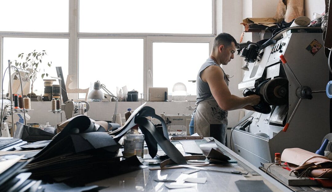 A craftsman working with industrial machinery in a leather workshop, focused and detailed.