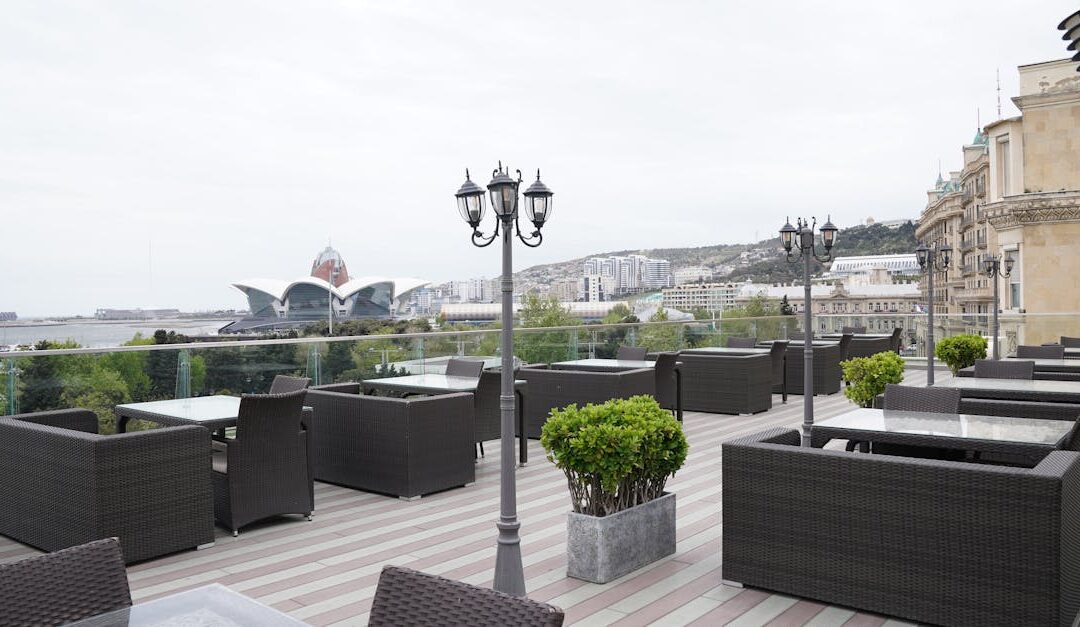 Spacious outdoor terrace with modern furniture and city landscape view. Ideal for leisure or business events.