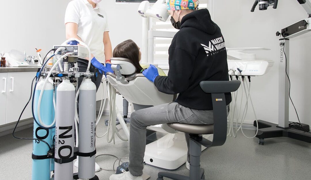 Dentist and assistant performing dental procedure with modern equipment in Kiev clinic.