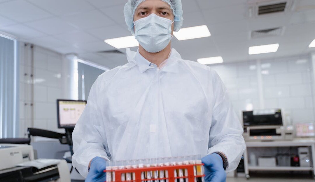 Scientist in protective gear examining samples in a modern laboratory.
