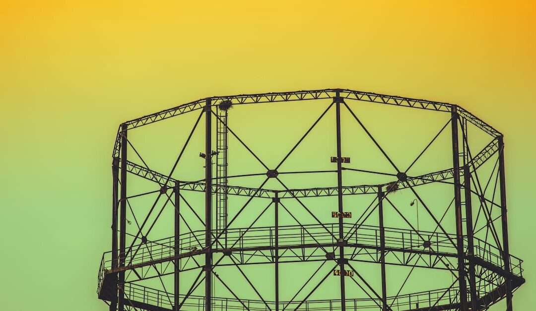 A geometric steel structure silhouetted against a vibrant sunset sky, showcasing industrial design.