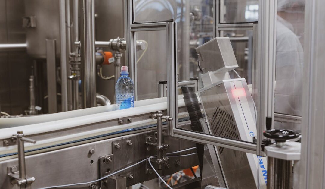 Close-up of a plastic bottle in a modern factory bottling production line.
