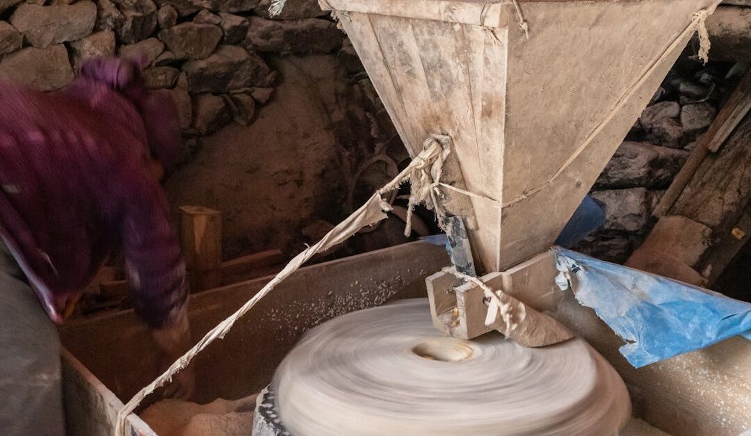 A traditional stone mill used for grinding grains in a rural Nepali village, showcasing local craftsmanship.