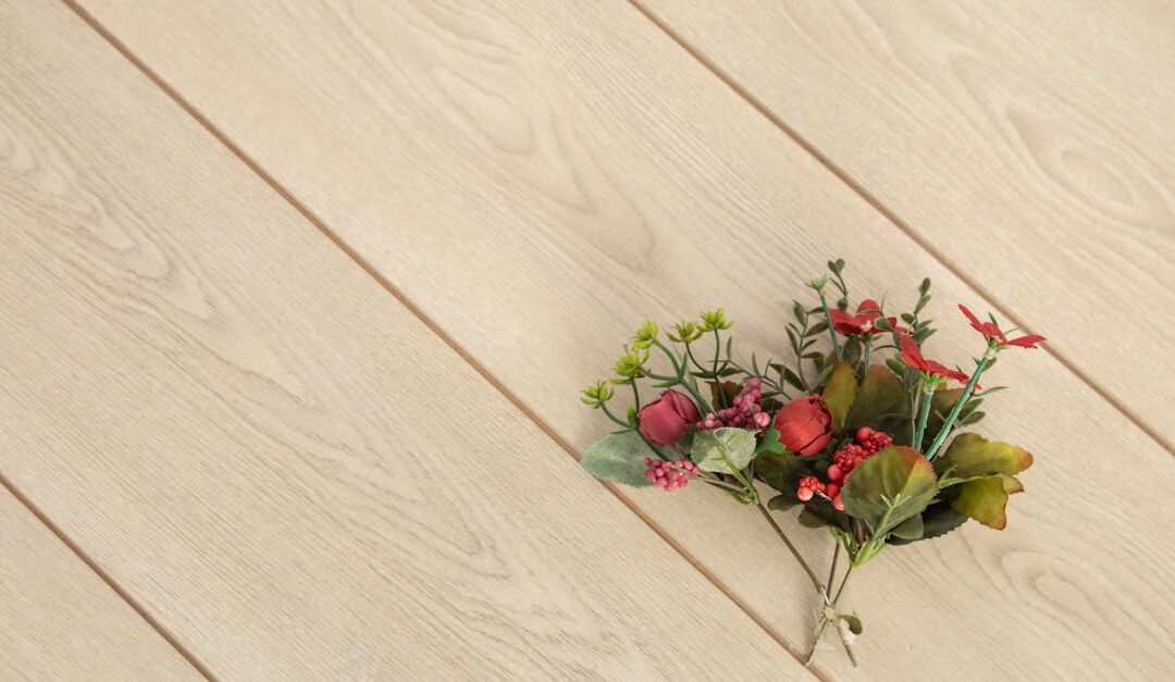 A vibrant floral bunch placed on a beige wooden background, adding a touch of nature indoors.