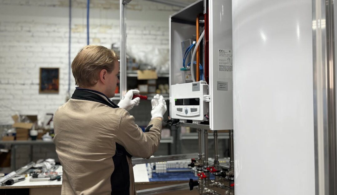 Technician inspects and repairs a heating system in an industrial workshop setting.
