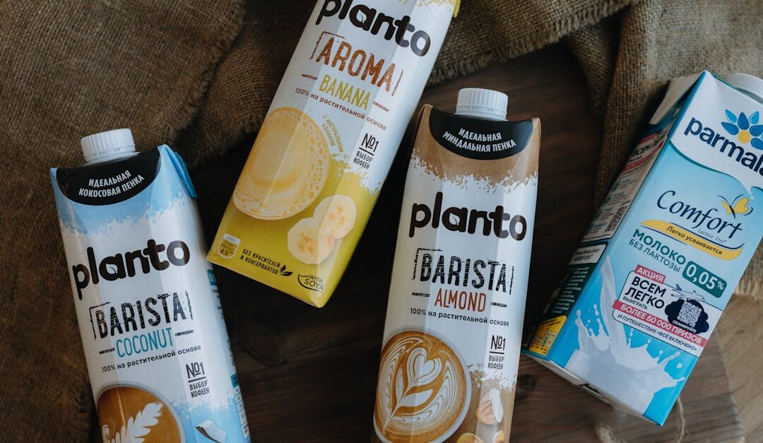 Assorted plant-based milk cartons including almond, coconut, and banana varieties.