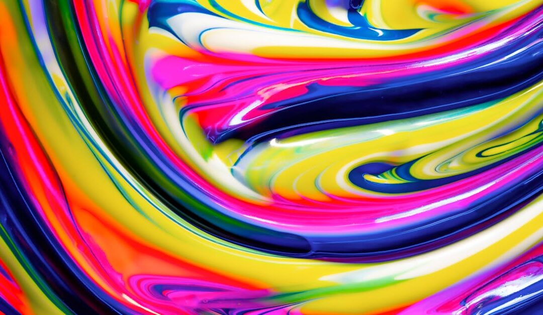 Dynamic and colorful swirl of multicolored acrylic paint creating an abstract and artistic expression.