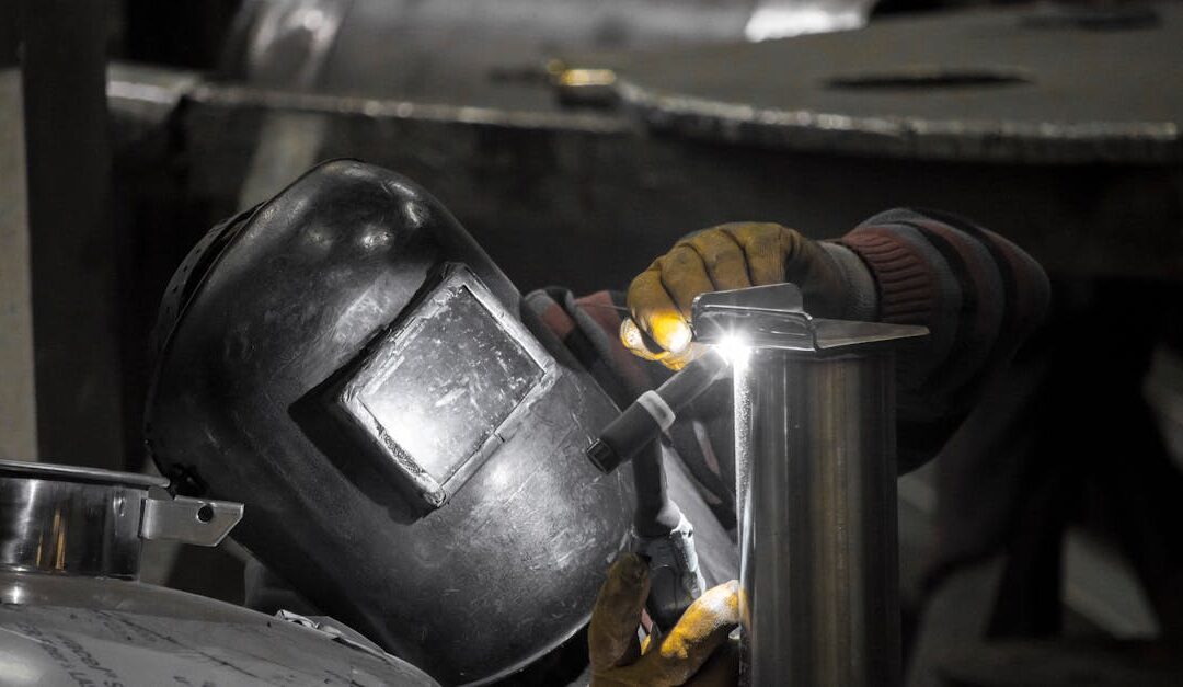 Welder in workshop welding metal parts with precision in İstanbul.