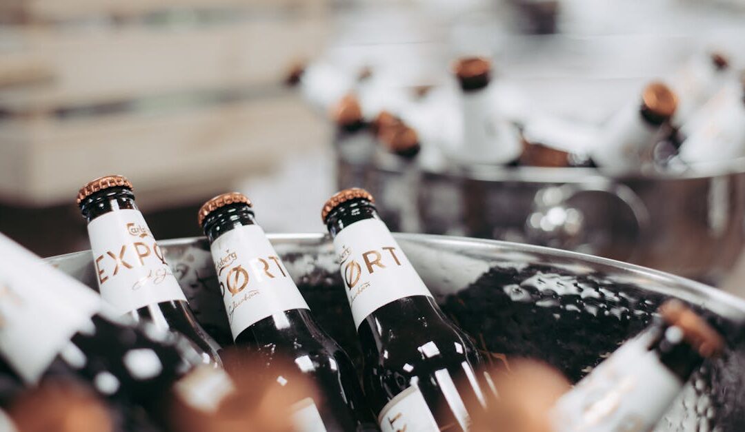 Close-up of chilled beer bottles in an ice bucket at a party. Perfect for beverage-themed images.
