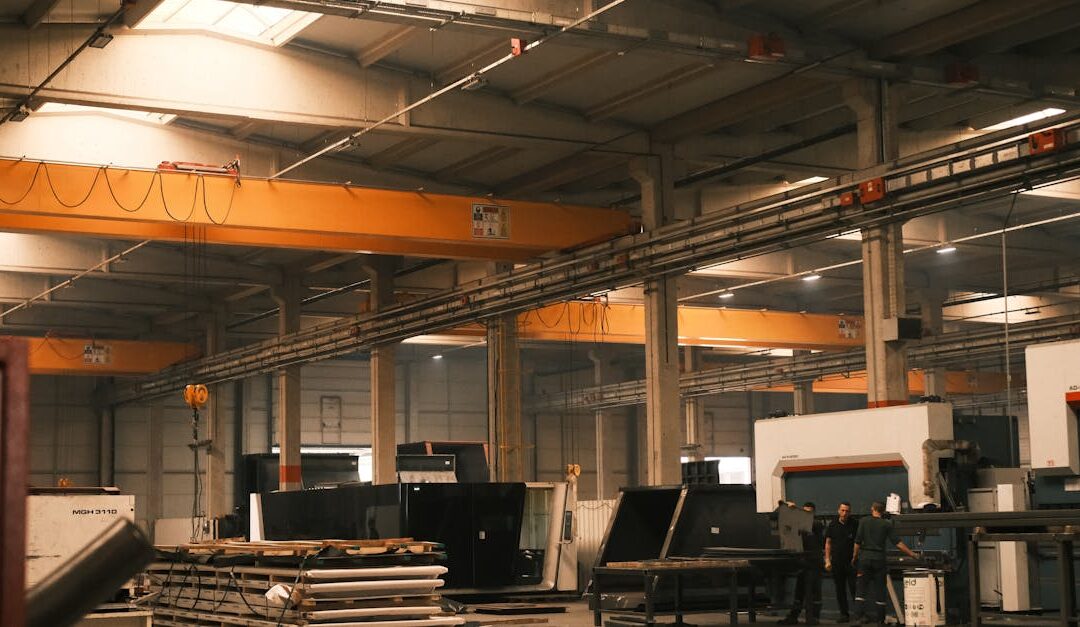 Interior view of an industrial warehouse with machinery and overhead cranes in Konya, Türkiye.