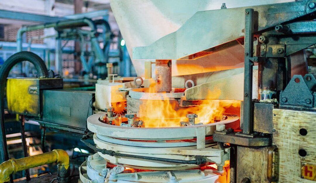 Fiery glassmaking process in a Dar es Salaam factory showcasing industrial machinery.