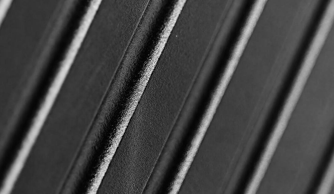 Abstract macro shot of a black textured surface showcasing intricate diagonal lines.