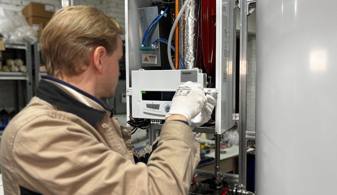 Technician installing or repairing a heating system in an indoor workshop setting.