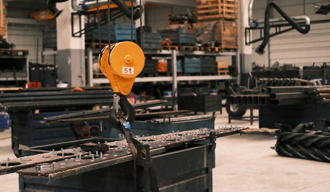 Close-up of a yellow industrial crane hook in a manufacturing workshop in Konya, Türkiye, showcasing metalwork.