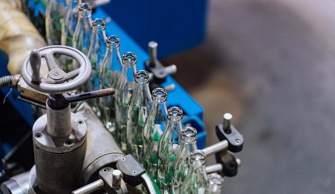 Close-up of glass bottling machinery in action, showcasing industrial precision.